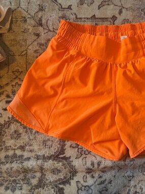 Lululemon bright orange hotty hot shorts in size 4 Tall